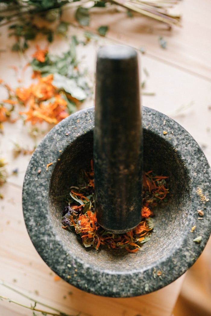 Discover the natural healing power with this mortar and pestle filled with dried herbs.